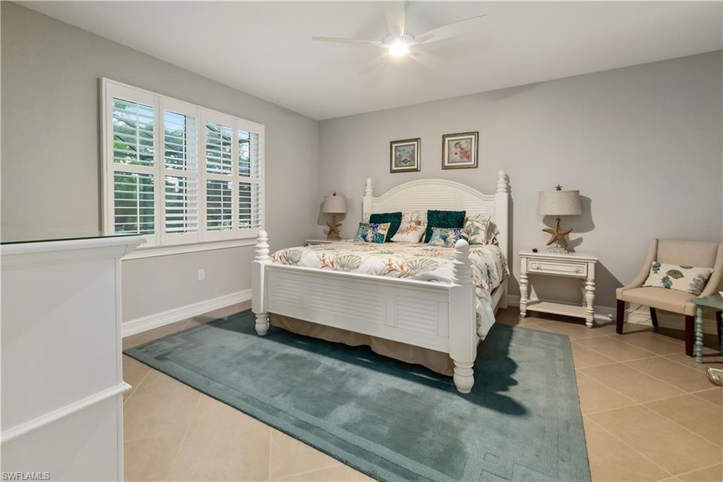 14671 Topsail Drive Naples, FL 34114 - Photo 8 of 26 a room with a bed and a large window
