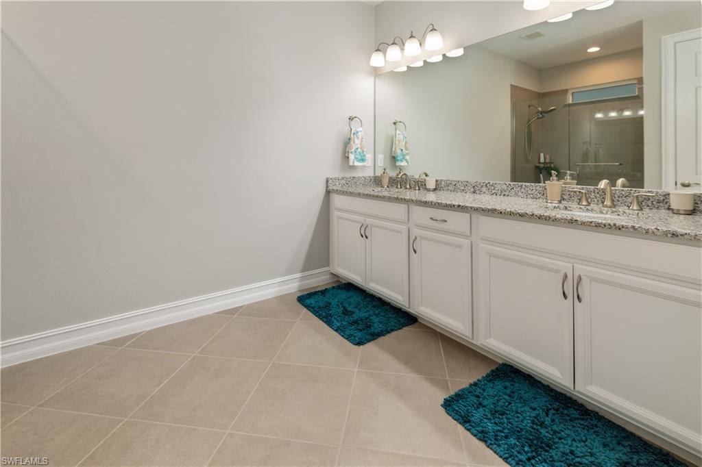14671 Topsail Drive Naples, FL 34114 - Photo 9 of 26 a bathroom with a sink vanity and a mirror