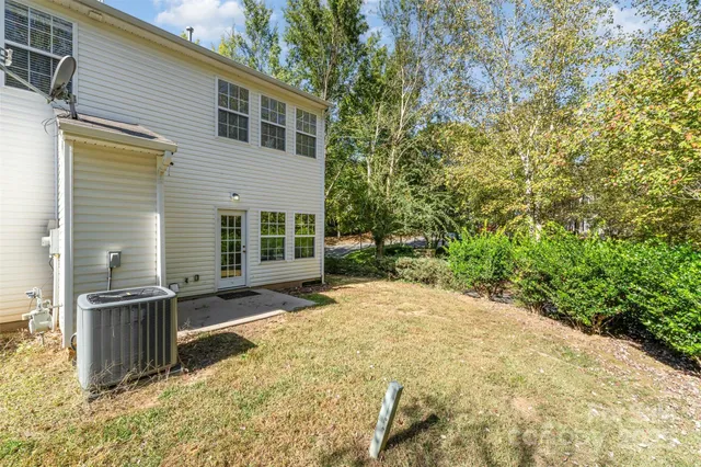 a view of backyard with a large tree