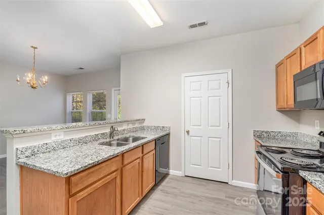 a kitchen with a sink stove and cabinets