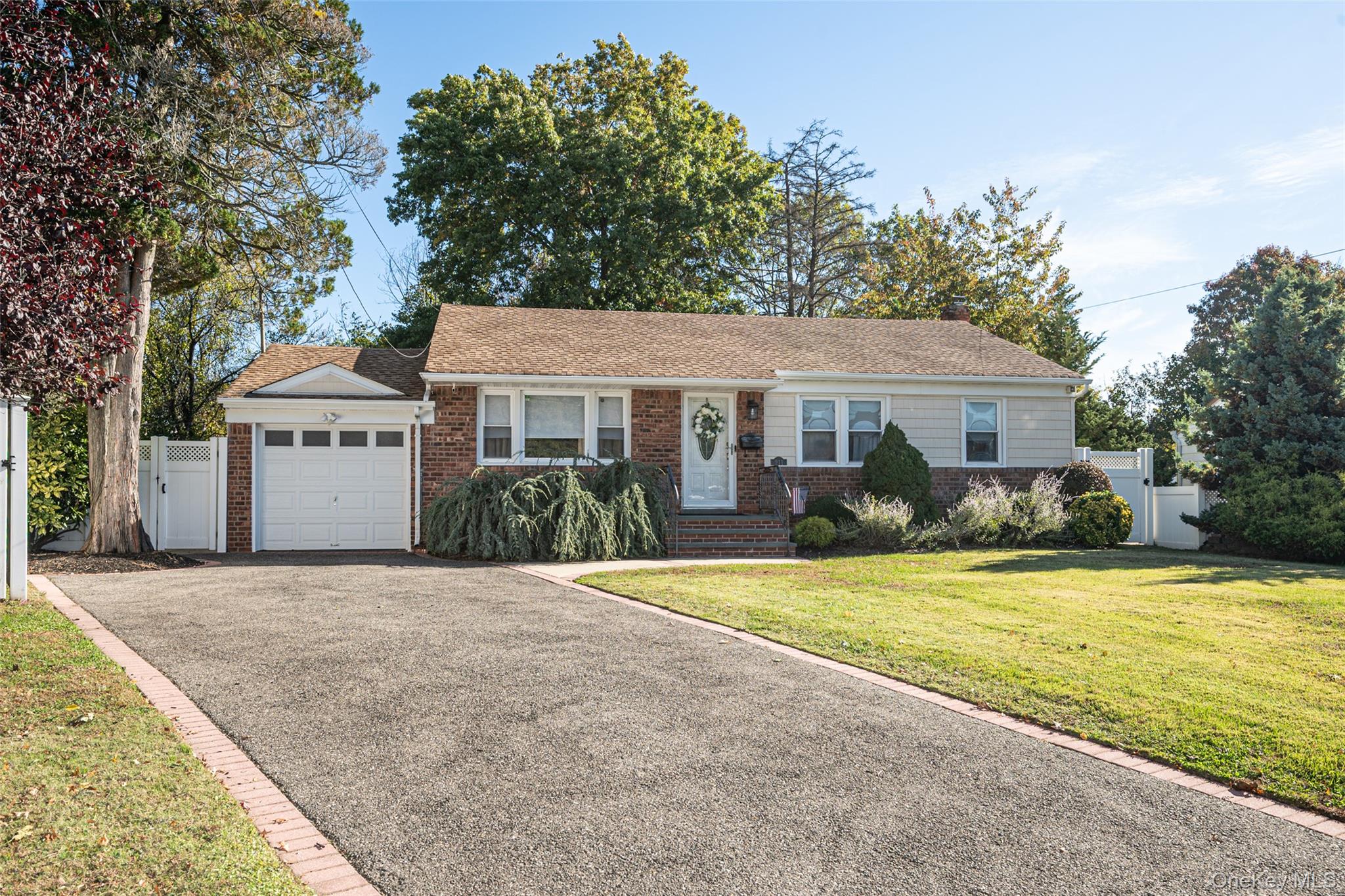 211 Gardner Avenue Jericho, NY 11753 - Photo 2 of 36 a front view of a house with a yard and garage