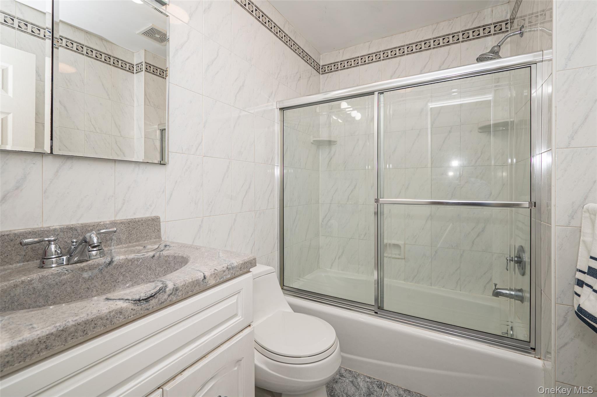 211 Gardner Avenue Jericho, NY 11753 - Photo 20 of 36 a bathroom with a granite countertop sink toilet and shower
