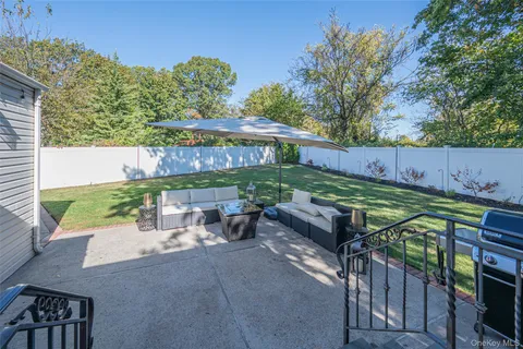 a view of a backyard with sitting area and furniture
