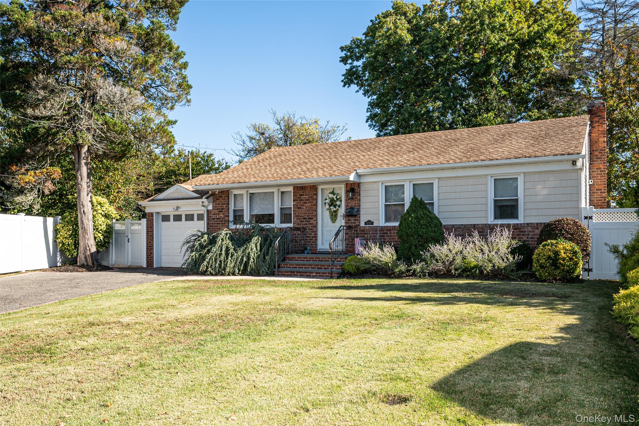 211 Gardner Avenue Jericho, NY 11753 - Photo 3 of 36 a front view of a house with swimming pool