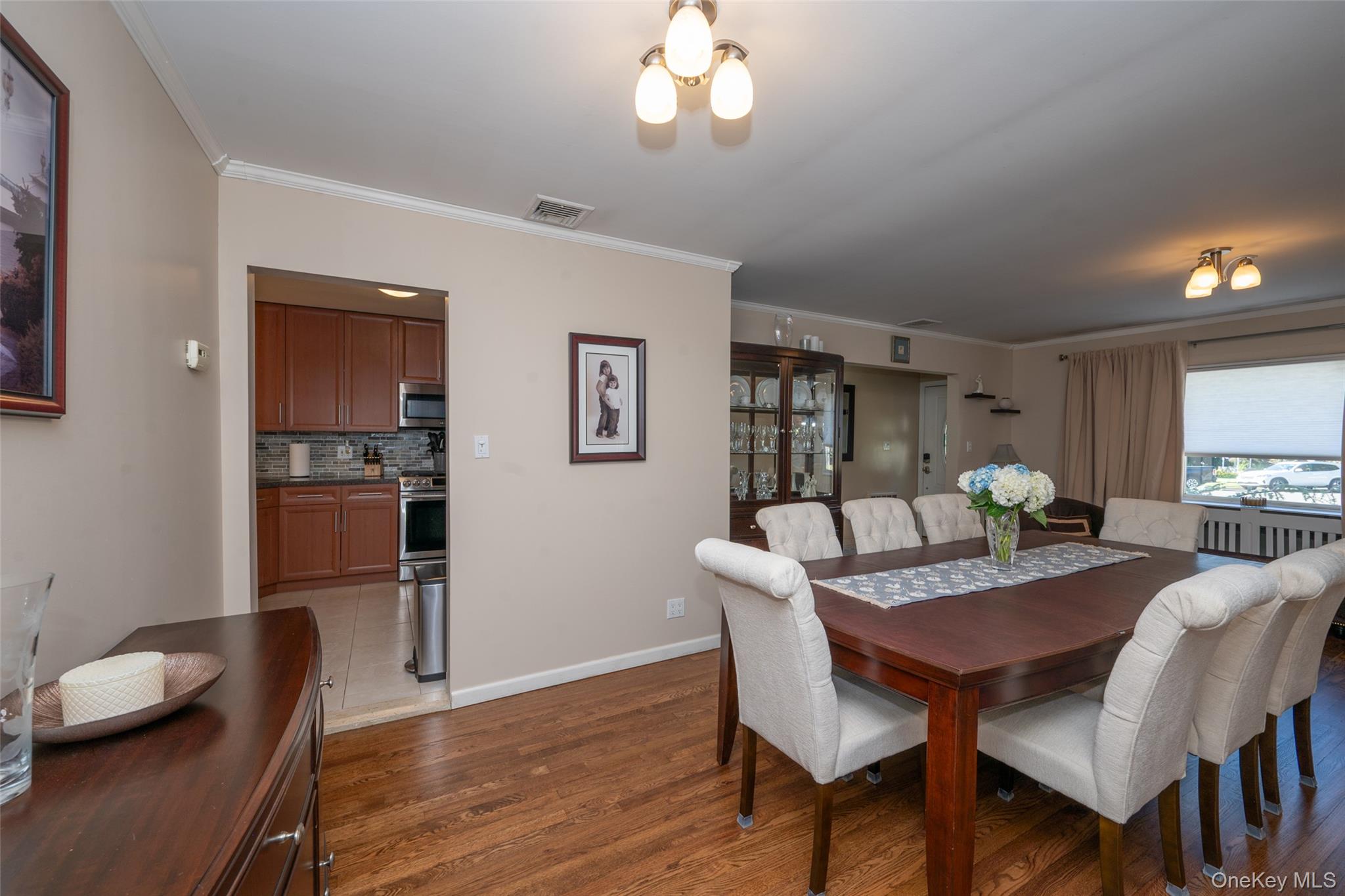 211 Gardner Avenue Jericho, NY 11753 - Photo 8 of 36 a view of a dining room with furniture and wooden floor