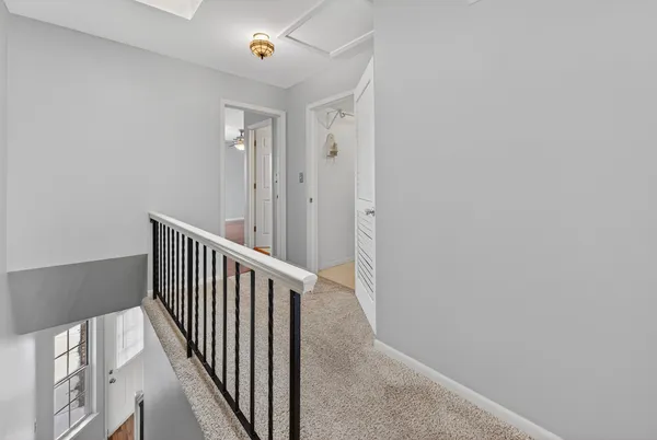 a view of a hallway with wooden floor and entryway