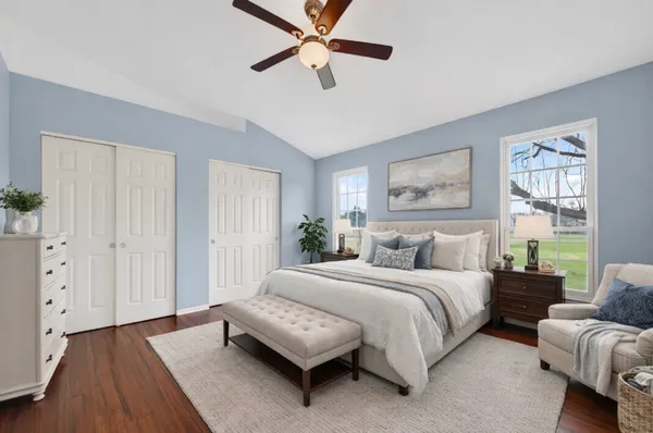 a bedroom with a bed couch and a window