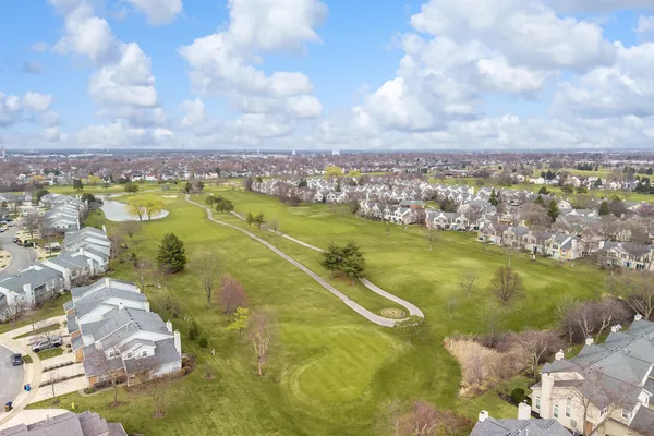 an aerial view of residential houses with outdoor space