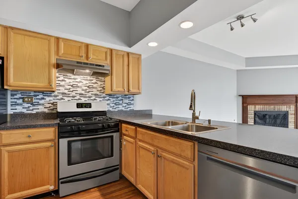 a kitchen with a sink stove and microwave