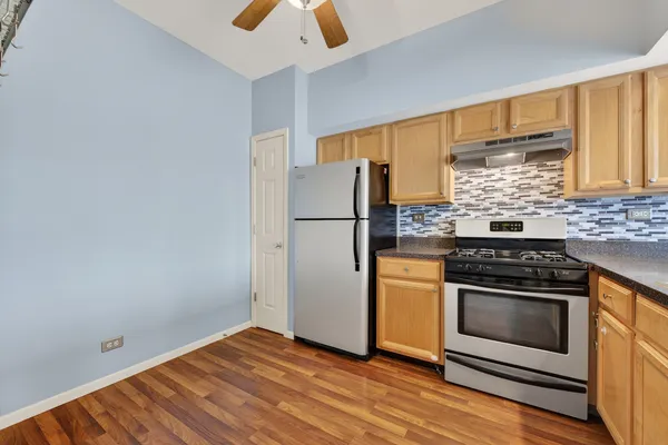 a kitchen with a stove refrigerator and microwave