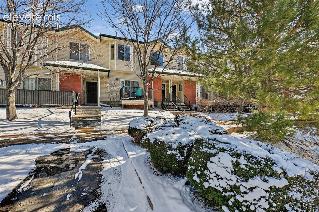 2141 Legacy Ridge View, Unit 109 Colorado Springs, CO 80910 - Photo 21 of 23 a front view of multiple houses with yard