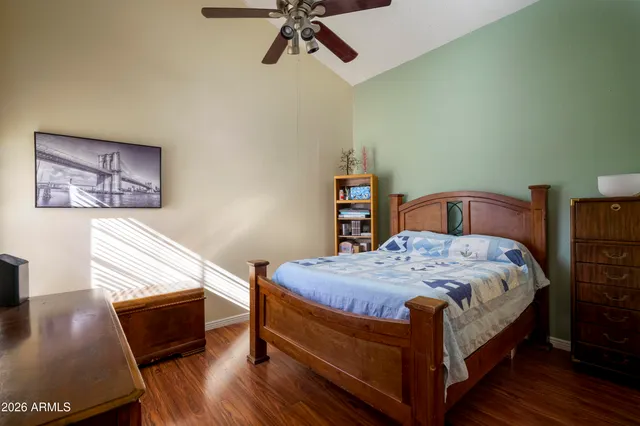 a bedroom with a bed and wooden floor