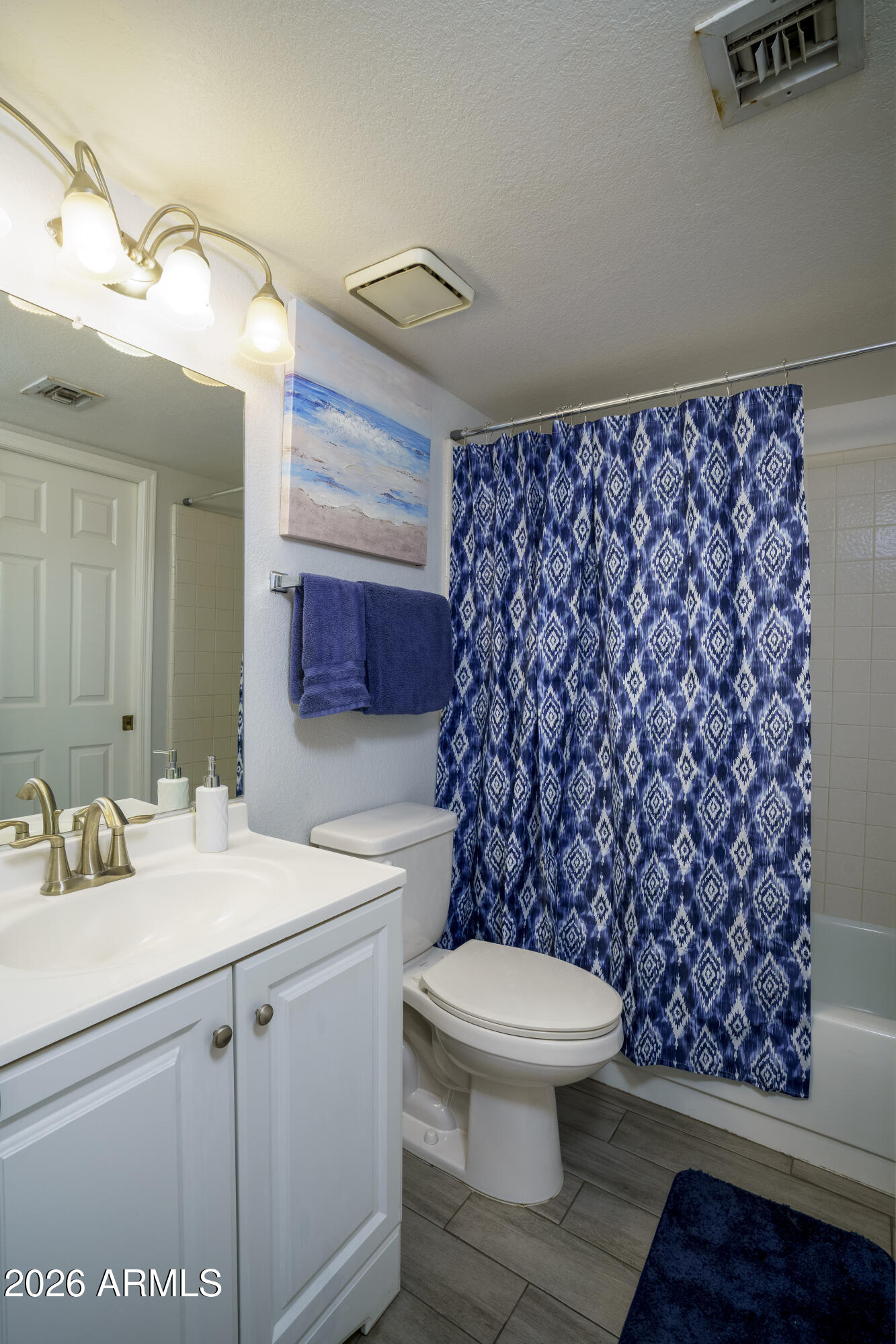 3030 South Alma School Road, Unit 28 Mesa, AZ 85202 - Photo 16 of 17 a bathroom with a sink a toilet and a mirror