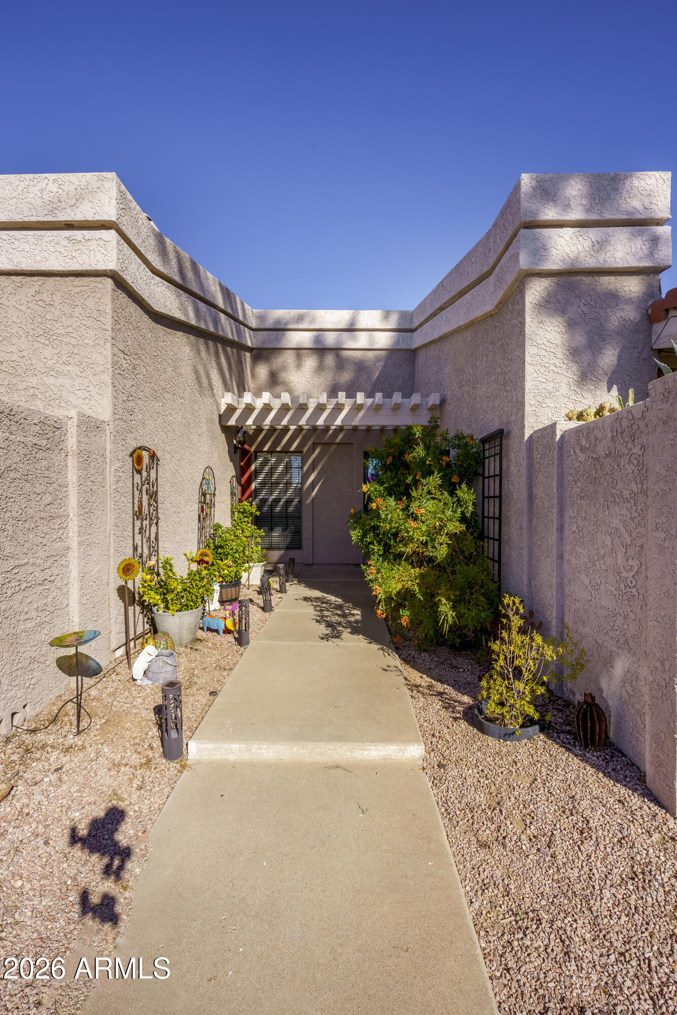 3030 South Alma School Road, Unit 28 Mesa, AZ 85202 - Photo 2 of 17 a front view of a house with a yard