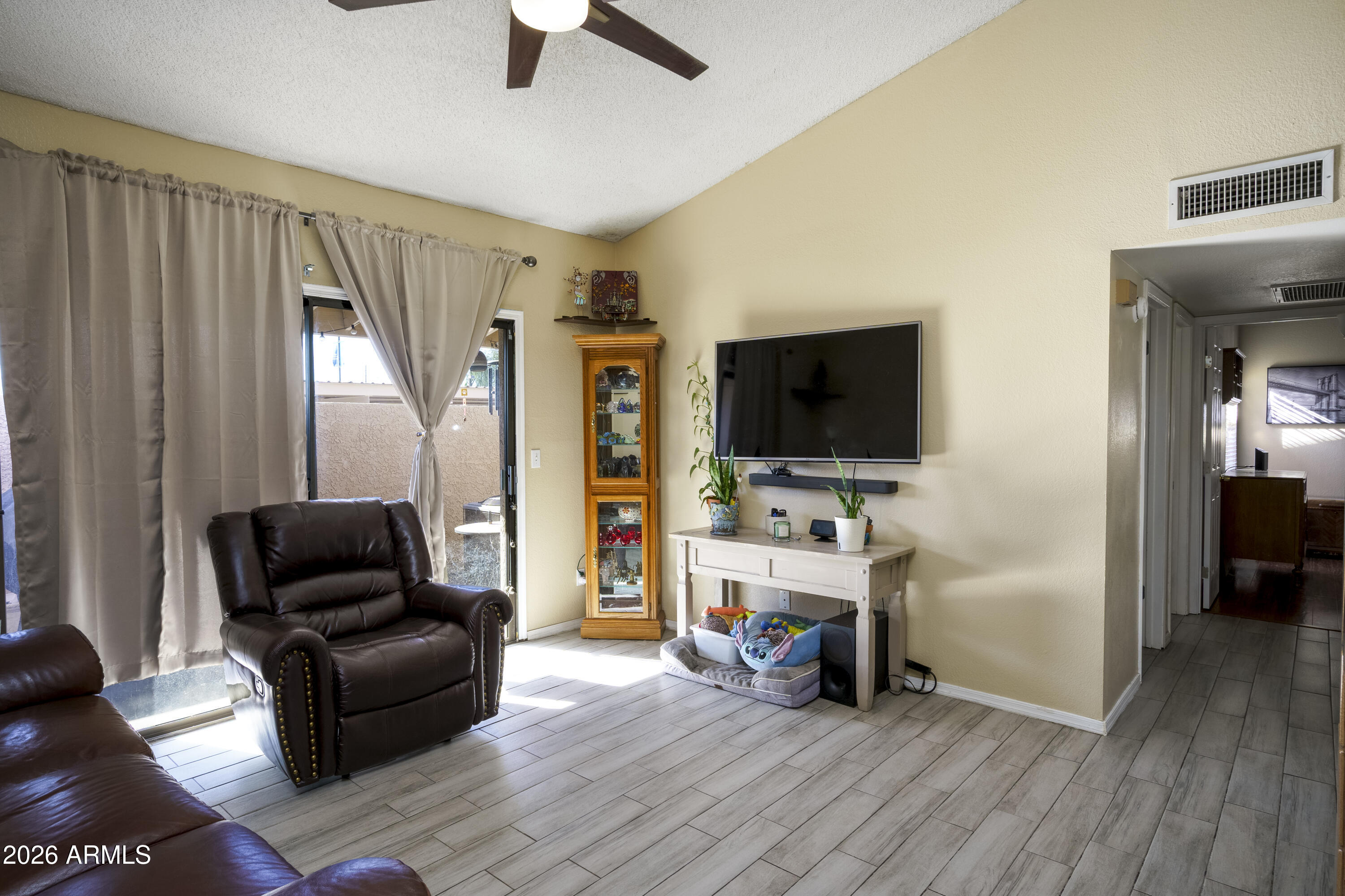 3030 South Alma School Road, Unit 28 Mesa, AZ 85202 - Photo 4 of 17 a living room with furniture and a flat screen tv
