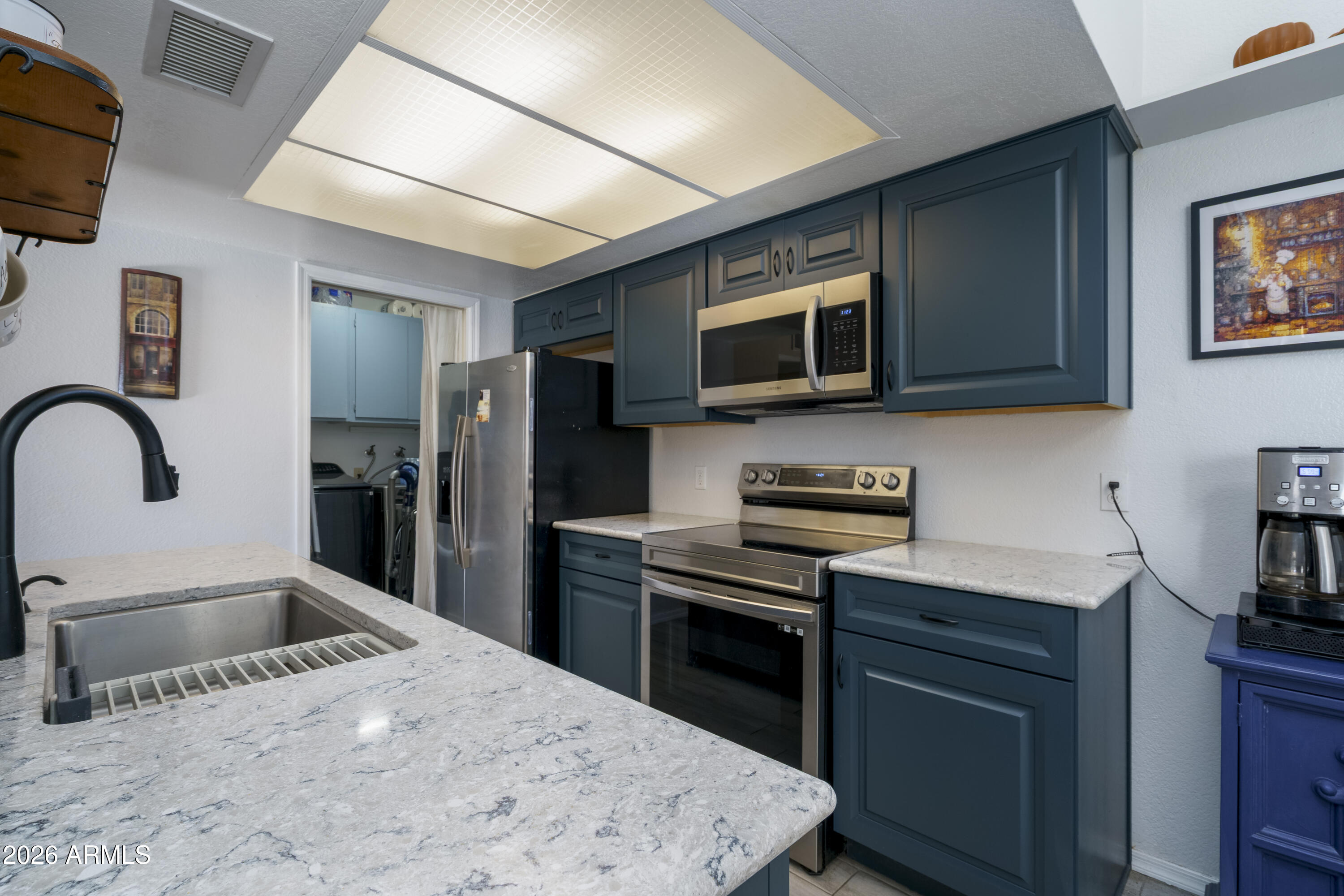 3030 South Alma School Road, Unit 28 Mesa, AZ 85202 - Photo 8 of 17 a kitchen with a sink cabinets and stainless steel appliances