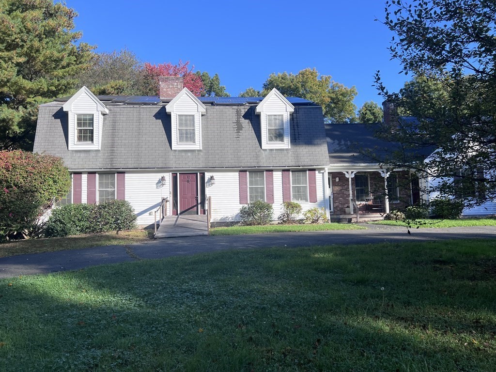 12 Woodsley Road Wilbraham, MA 01095 - Photo 1 of 15 a front view of a house with garden and porch