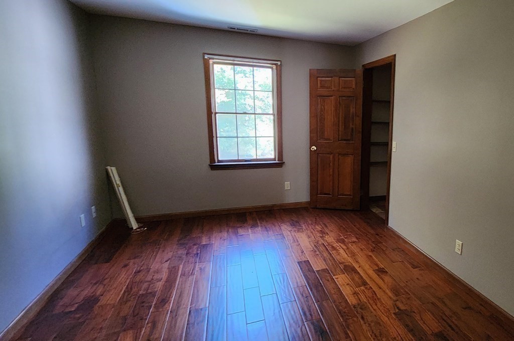 12 Woodsley Road Wilbraham, MA 01095 - Photo 14 of 15 an empty room with wooden floor and windows