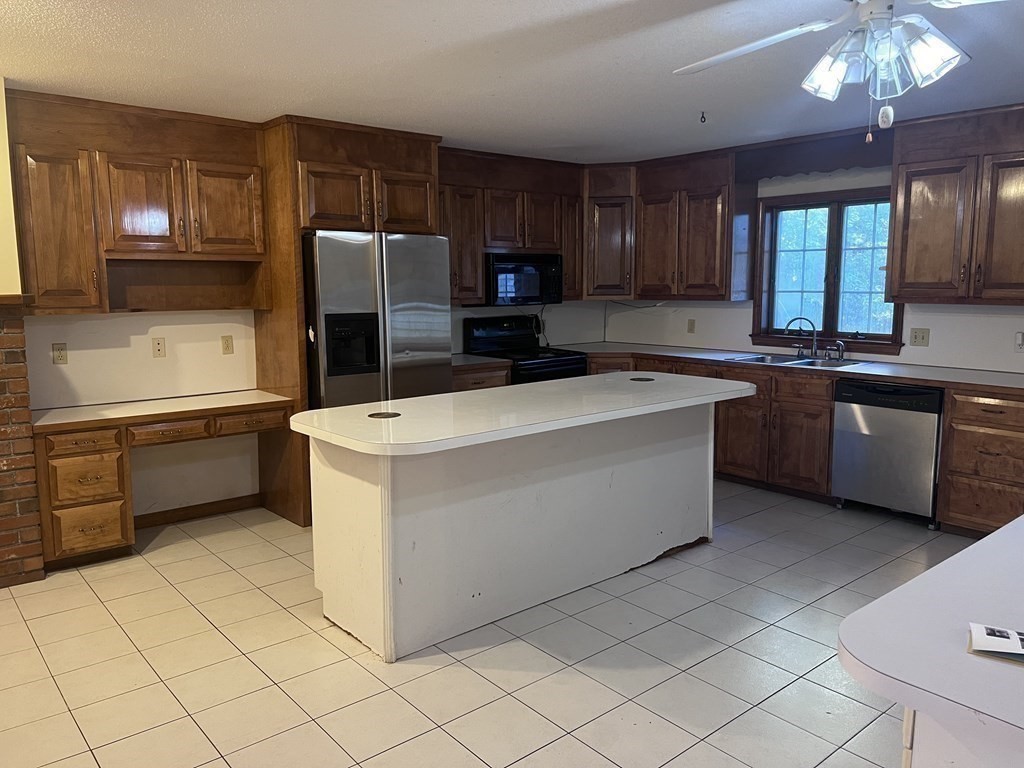 12 Woodsley Road Wilbraham, MA 01095 - Photo 5 of 15 a kitchen with stainless steel appliances a sink and a stove top oven