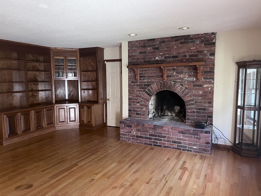 12 Woodsley Road Wilbraham, MA 01095 - Photo 7 of 15 a living room with furniture fireplace and wooden floor