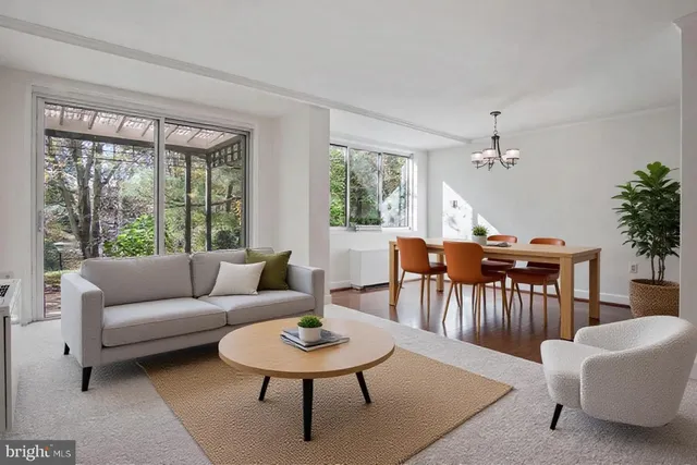 a living room with furniture a table and a large window