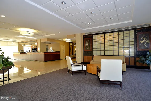 a living room with furniture and large windows