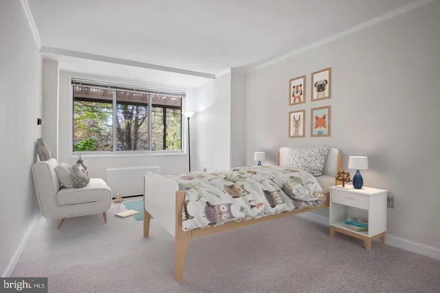a bedroom with bed and a large window