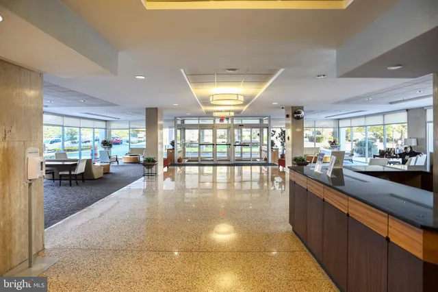 a lobby with furniture and a large window
