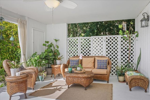 a living room with furniture and a potted plant