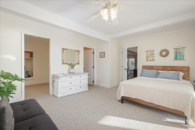 a bedroom with a bed and ceiling fan