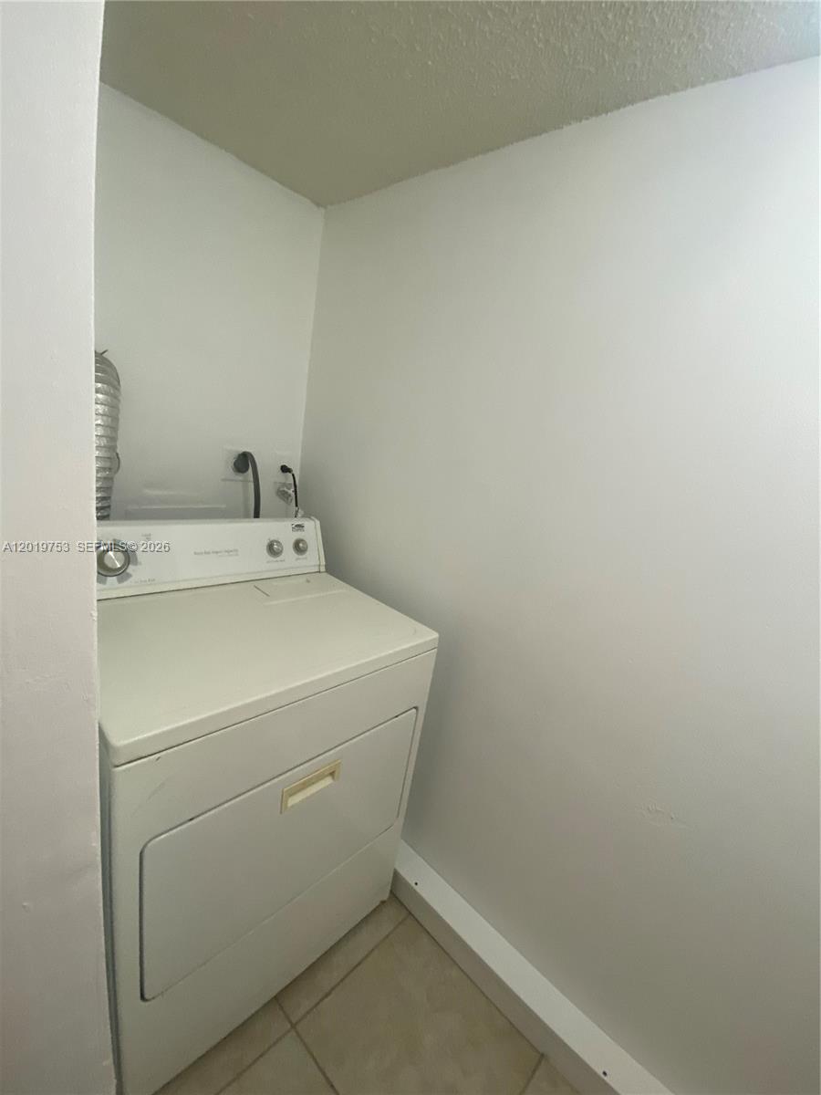 3410 Foxcroft Road, Unit 206 Miramar, FL 33025 - Photo 7 of 23 a utility room with dryer and washer