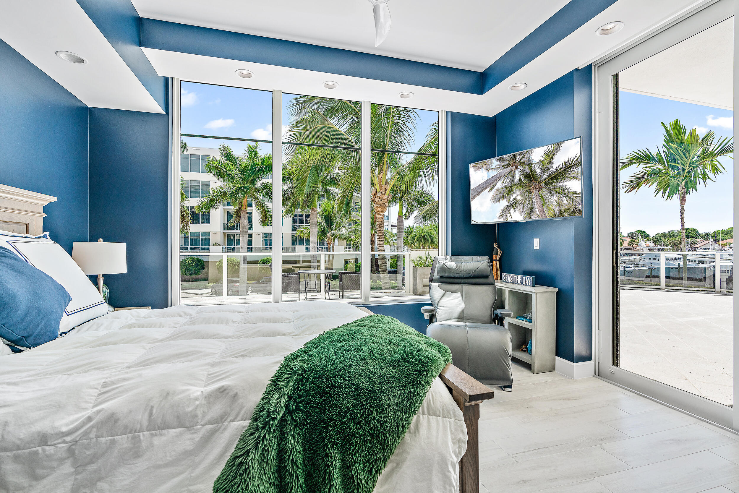 2720 Donald Ross Road, Unit 203 Palm Beach Gardens, FL 33410 - Photo 14 of 35 a large bedroom with a large bed and a large window with balcony view