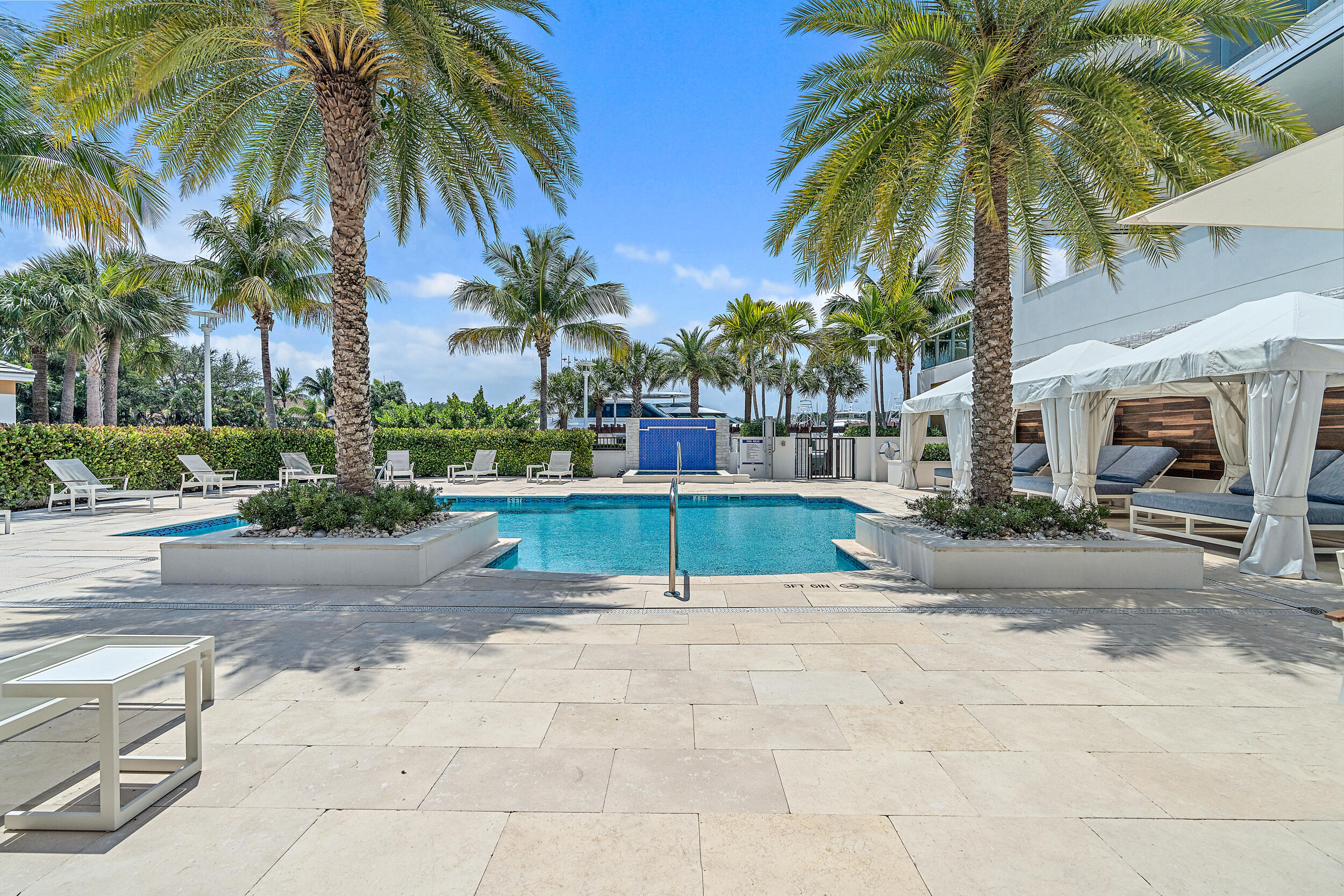 2720 Donald Ross Road, Unit 203 Palm Beach Gardens, FL 33410 - Photo 21 of 35 a view of a swimming pool with palm trees