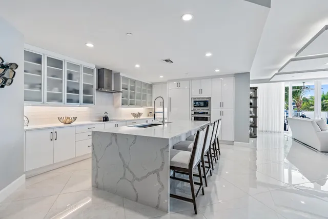 a kitchen with kitchen island a sink table and chairs