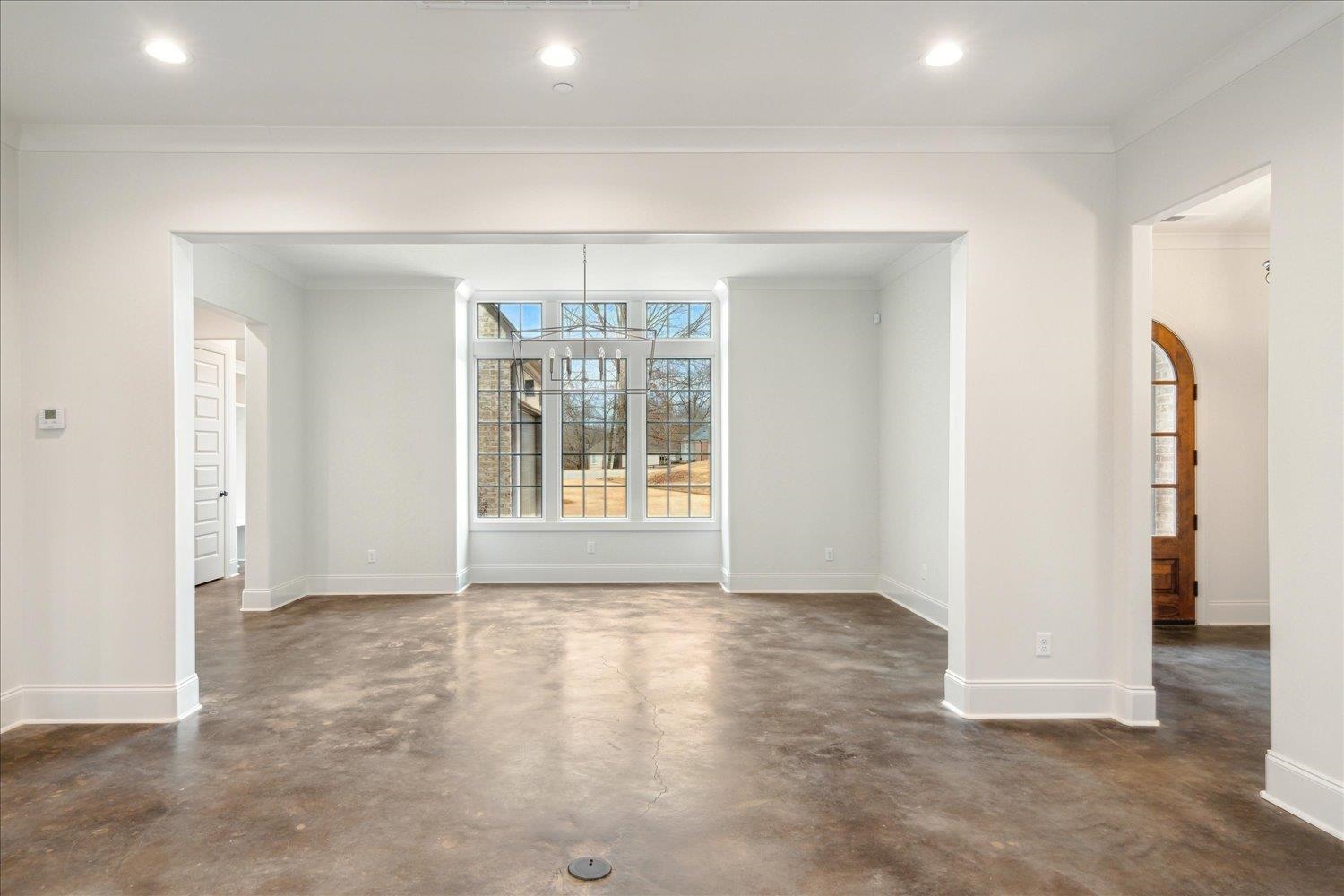 45 Magnolia Cove Piperton, TN 38017 - Photo 12 of 40 an empty room with chandelier fan and windows