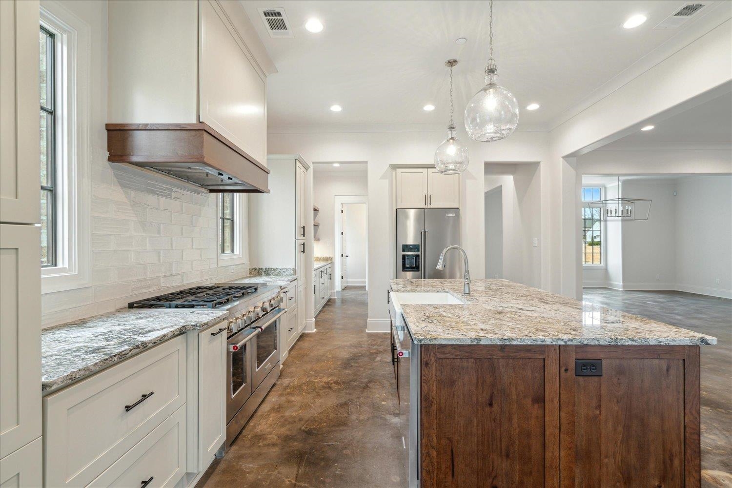 45 Magnolia Cove Piperton, TN 38017 - Photo 14 of 40 a large kitchen with stainless steel appliances granite countertop a lot of counter space and wooden floor