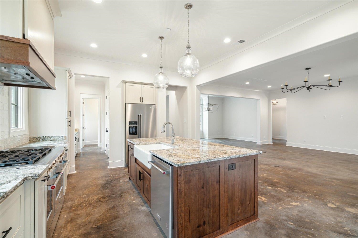 45 Magnolia Cove Piperton, TN 38017 - Photo 15 of 40 a large kitchen with kitchen island a stove a sink dishwasher and a refrigerator with wooden floor