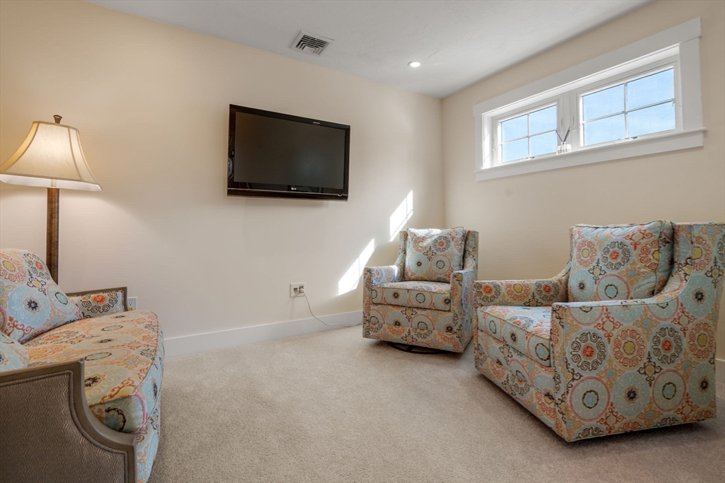 69 Abbey Road, Unit 69 Westwood, MA 02090 - Photo 14 of 16 a bedroom with furniture and a flat screen tv