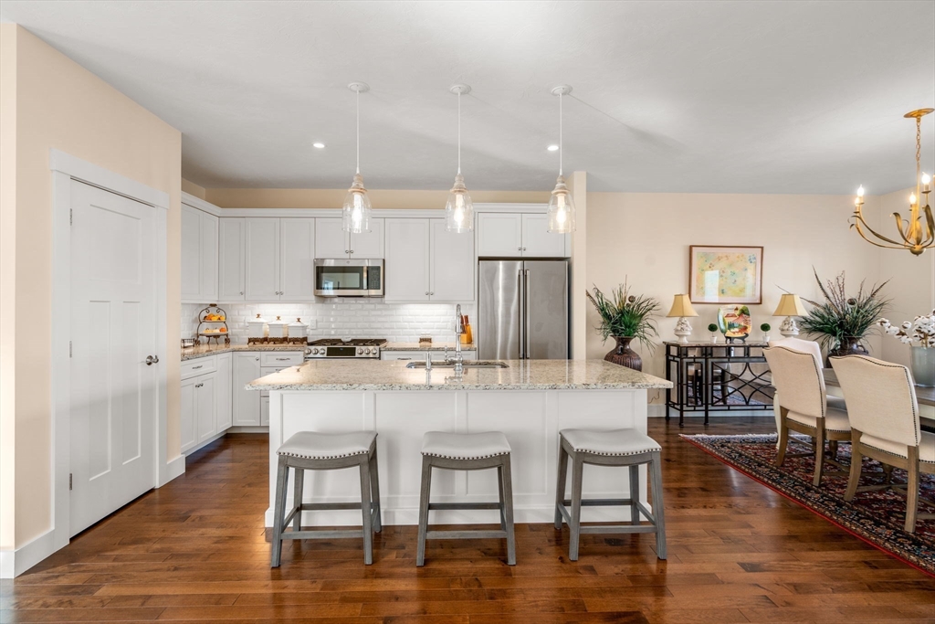 69 Abbey Road, Unit 69 Westwood, MA 02090 - Photo 2 of 16 a kitchen with white cabinets and stainless steel appliances
