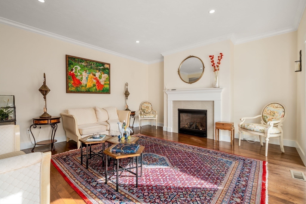 69 Abbey Road, Unit 69 Westwood, MA 02090 - Photo 5 of 16 a living room with furniture a rug and a fireplace