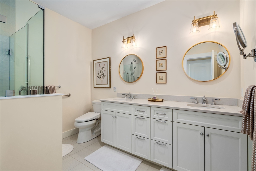 69 Abbey Road, Unit 69 Westwood, MA 02090 - Photo 7 of 16 a bathroom with a toilet a sink and a mirror