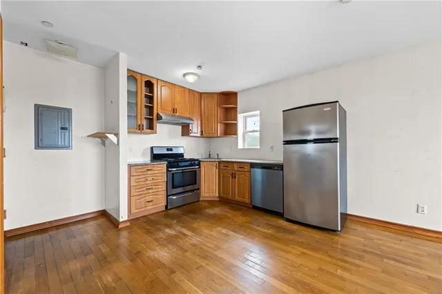 a kitchen with granite countertop a refrigerator and a stove