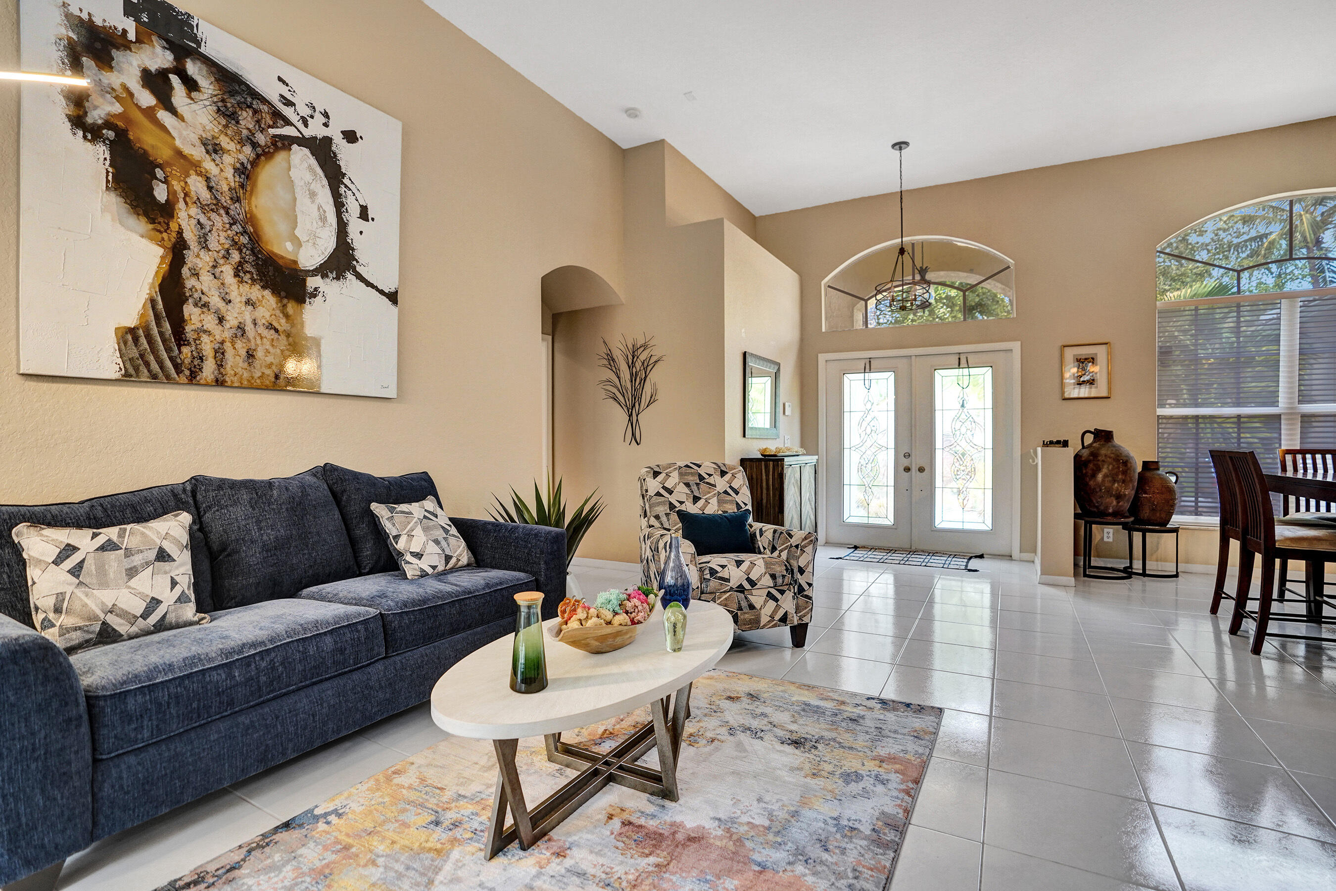 10063 Umberland Place Boca Raton, FL 33428 - Photo 11 of 97 a living room with furniture a dining table and a chandelier