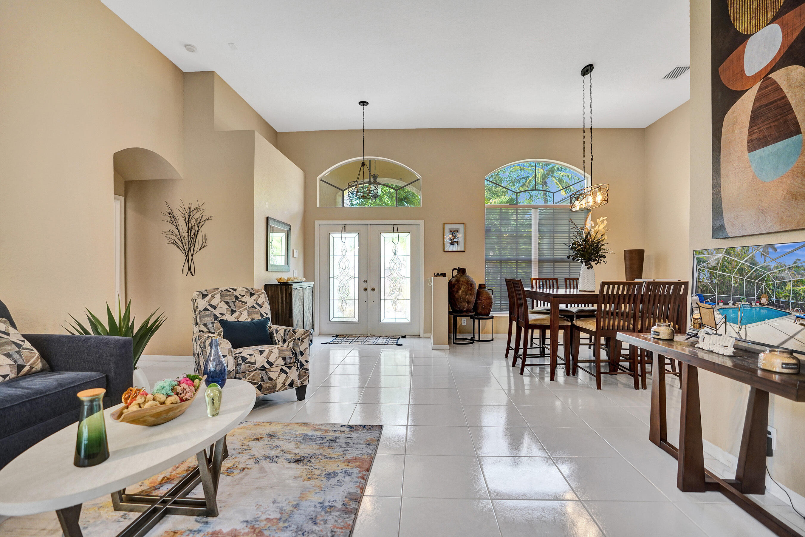 10063 Umberland Place Boca Raton, FL 33428 - Photo 12 of 97 a view of a dining room and livingroom with furniture a rug a potted plant and a chandelier