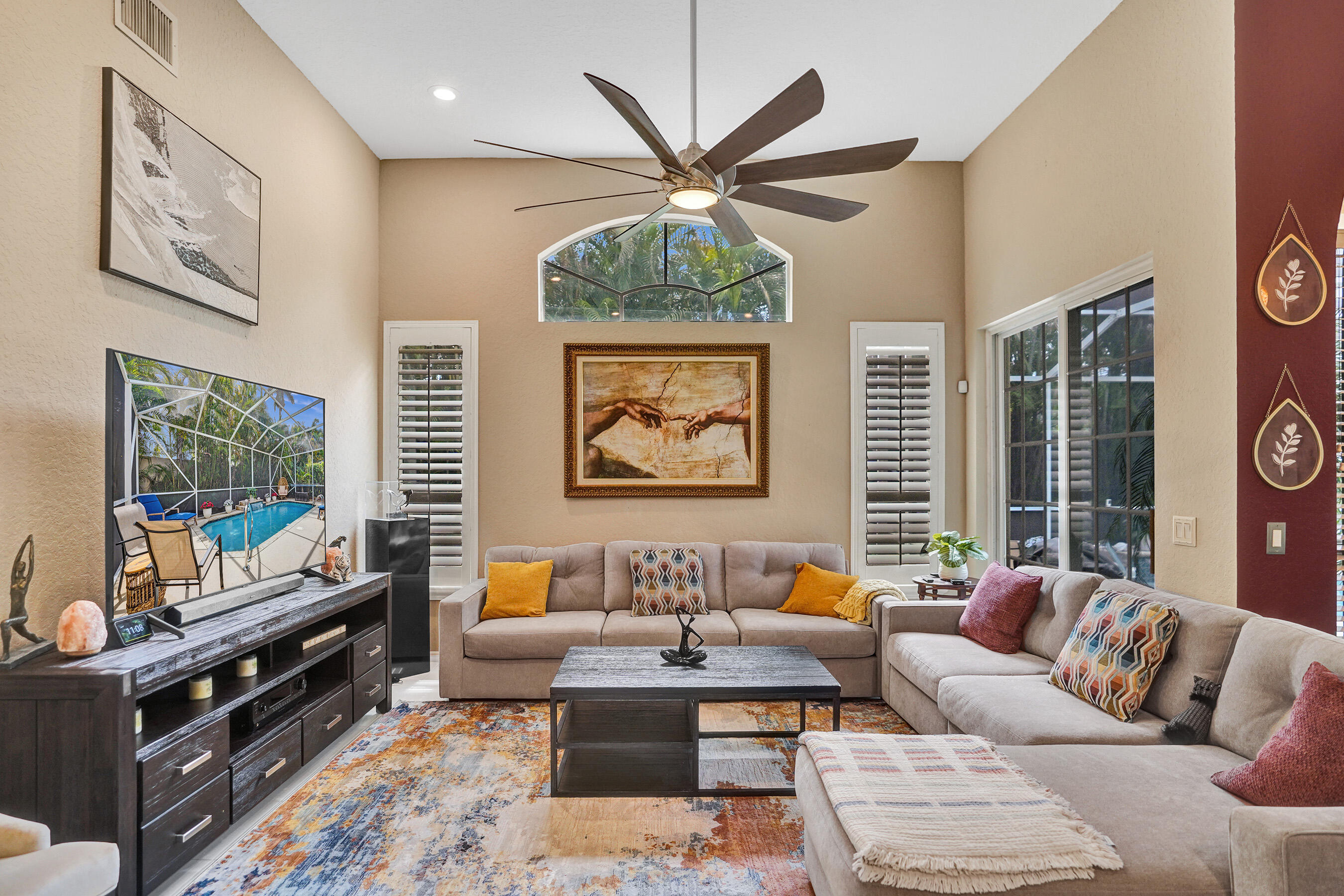 10063 Umberland Place Boca Raton, FL 33428 - Photo 15 of 97 a living room with furniture a flat screen tv and a window