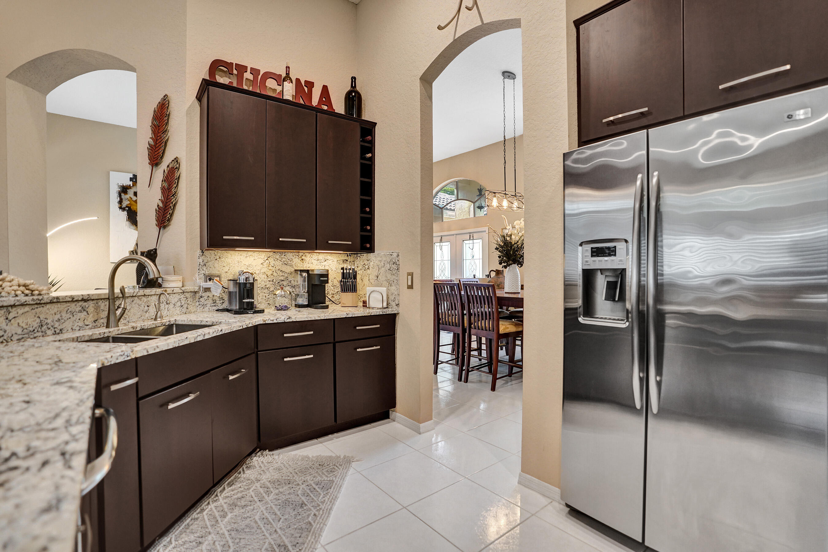 10063 Umberland Place Boca Raton, FL 33428 - Photo 31 of 97 a kitchen with stainless steel appliances granite countertop a refrigerator and a sink