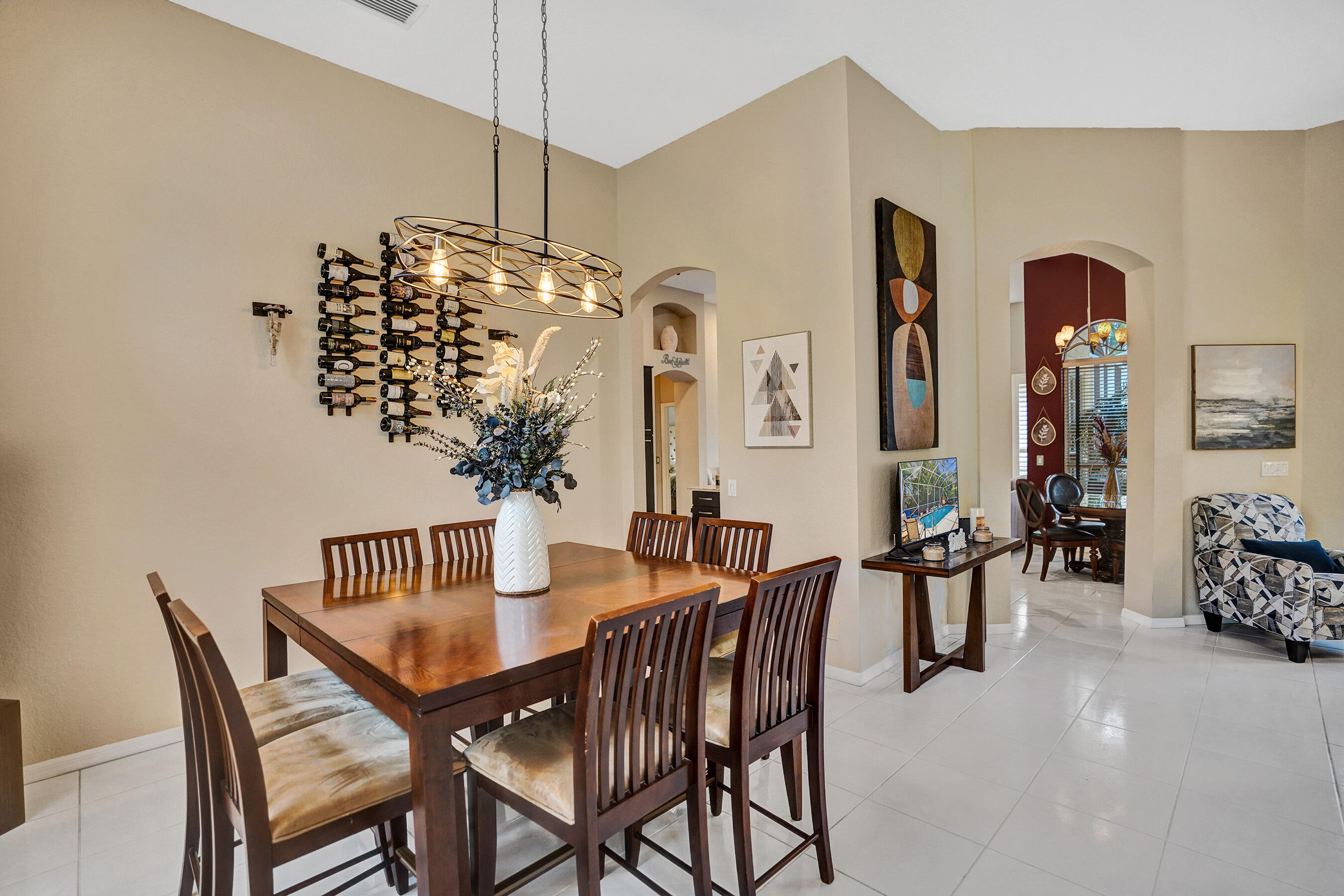 10063 Umberland Place Boca Raton, FL 33428 - Photo 35 of 97 a view of a dining room with furniture and chandelier