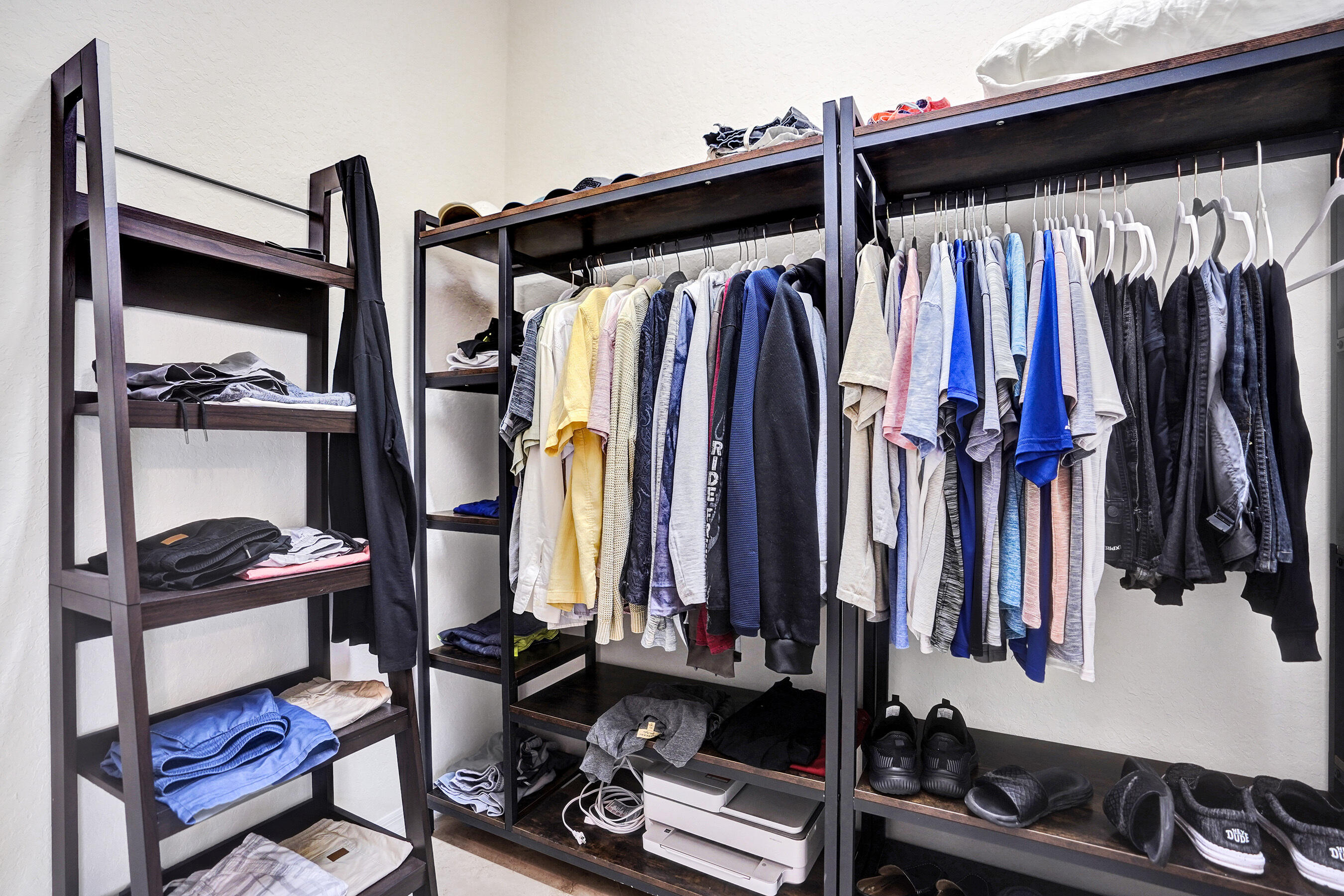 10063 Umberland Place Boca Raton, FL 33428 - Photo 42 of 97 a view of walk in closet with clothes and shoes