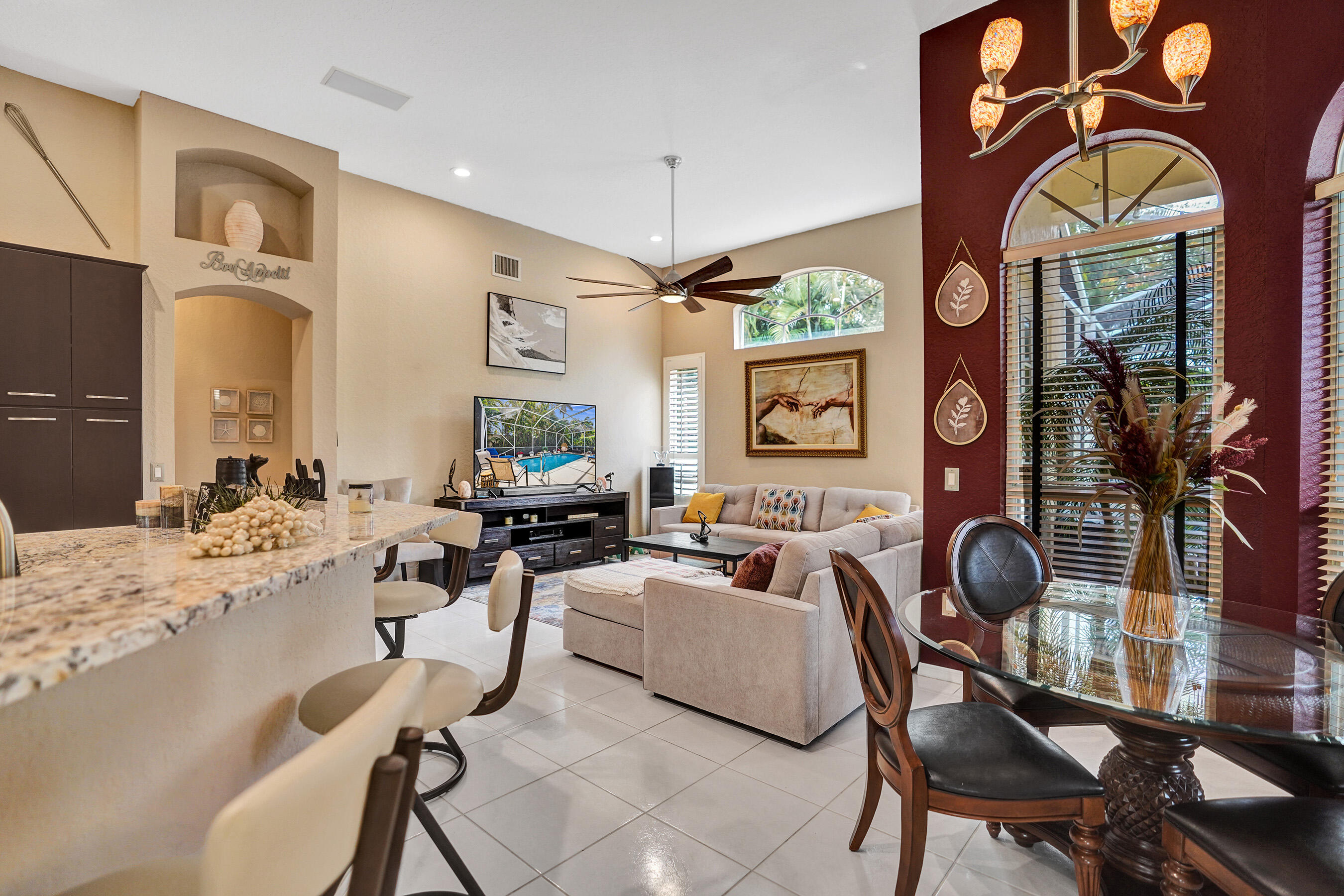 10063 Umberland Place Boca Raton, FL 33428 - Photo 5 of 97 a living room with furniture a window and gym equipment