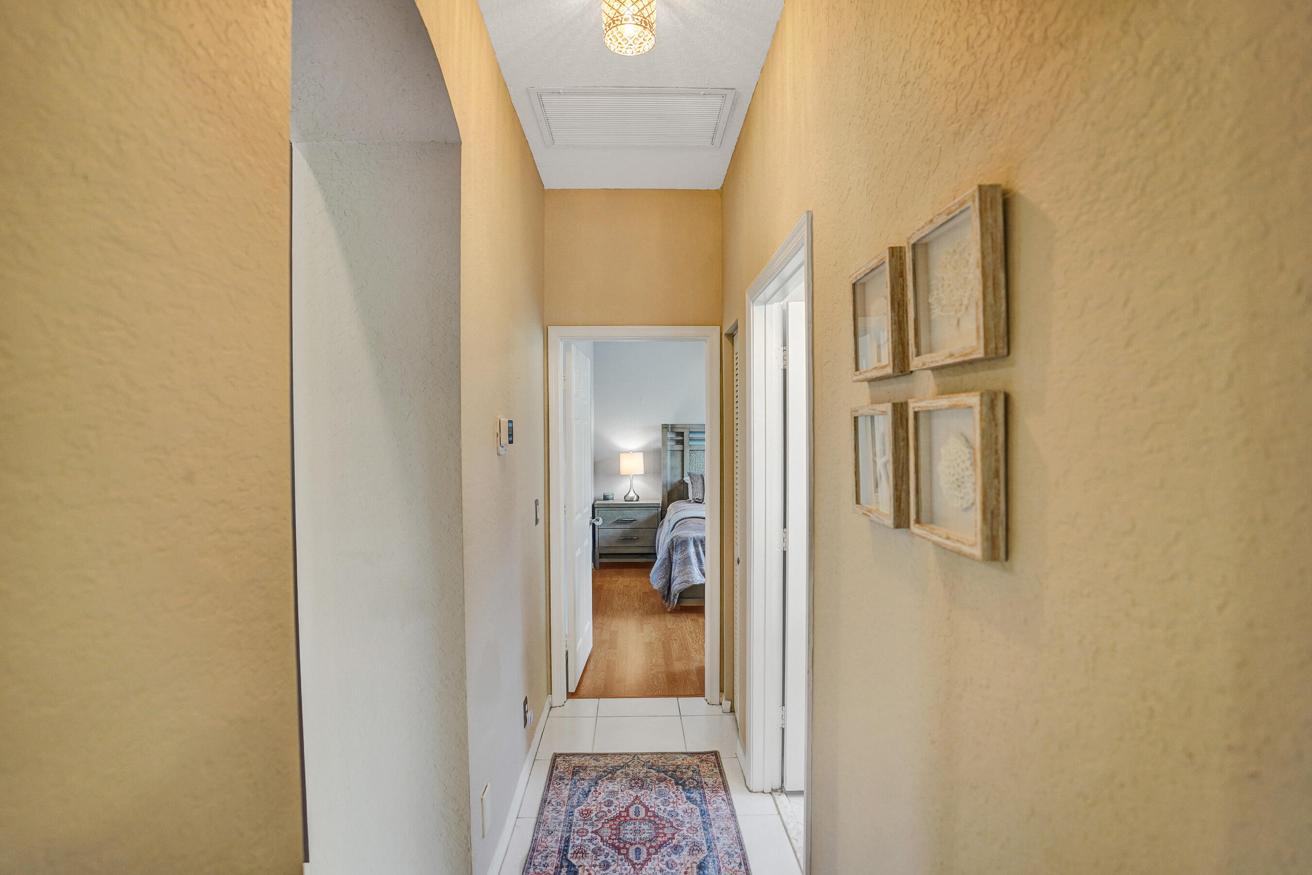 10063 Umberland Place Boca Raton, FL 33428 - Photo 51 of 97 a view of a hallway with wooden floor and a bathroom